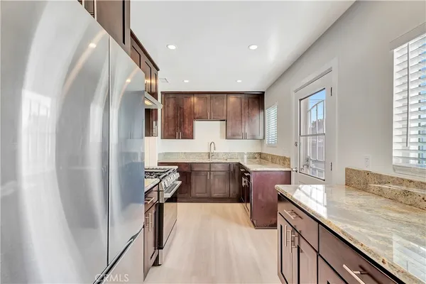 a kitchen with a sink stove and refrigerator