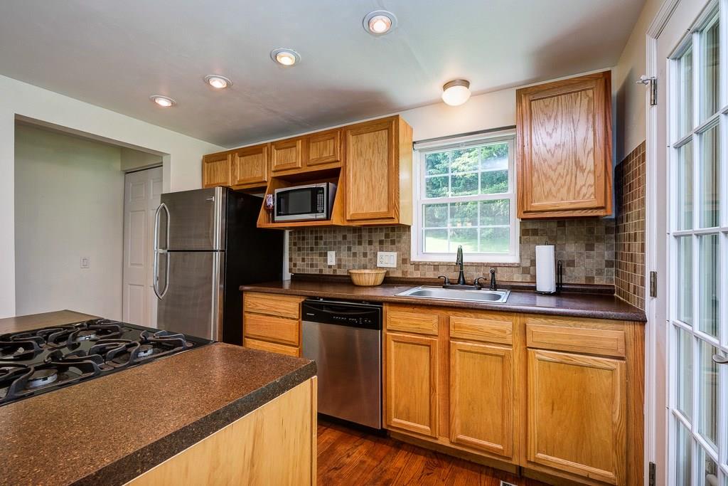4330 Highgrove Road Pittsburgh, PA 15234 - Photo 7 of 16 Updated kitchen with a stunning backsplash and stainless steel appliances