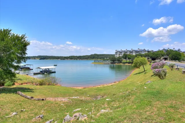 a view of a lake with houses in the back