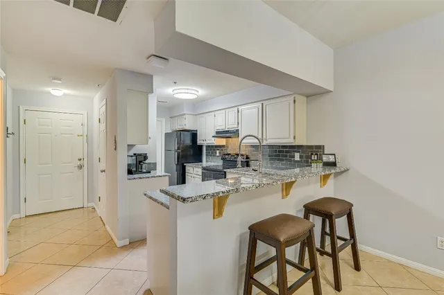a kitchen with a stove and cabinets