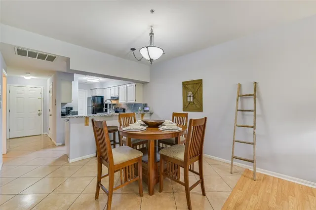 a kitchen with stainless steel appliances granite countertop a stove refrigerator and cabinets