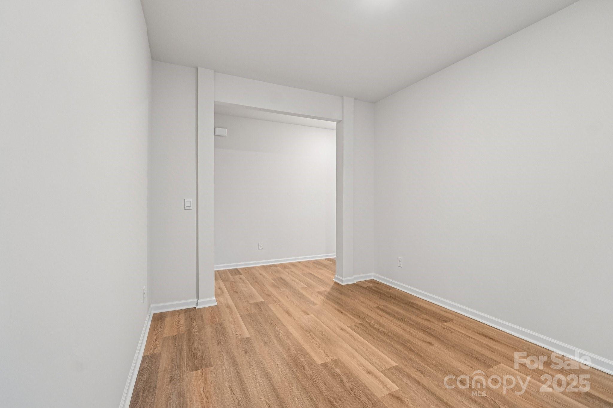 7636 Bainbridge Road Sherrills Ford, NC 28673 - Photo 14 of 31 a view of an empty room with wooden floor