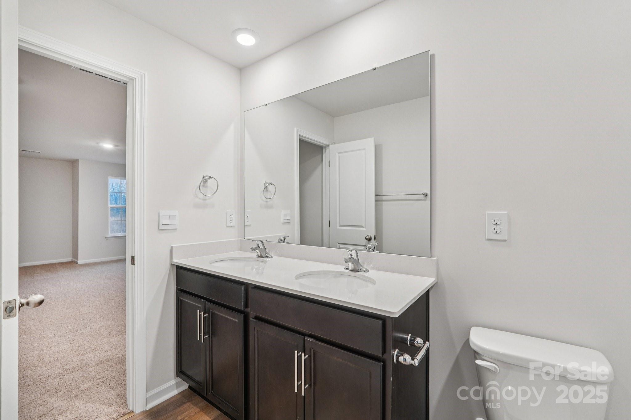 7636 Bainbridge Road Sherrills Ford, NC 28673 - Photo 26 of 31 a bathroom with a sink a toilet and a mirror