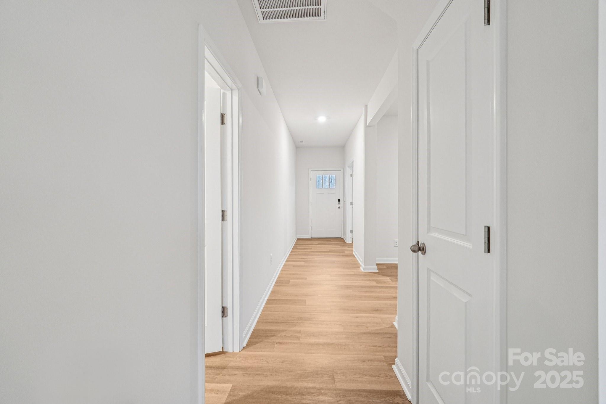 7636 Bainbridge Road Sherrills Ford, NC 28673 - Photo 3 of 31 a view of a hallway with wooden floor and staircase