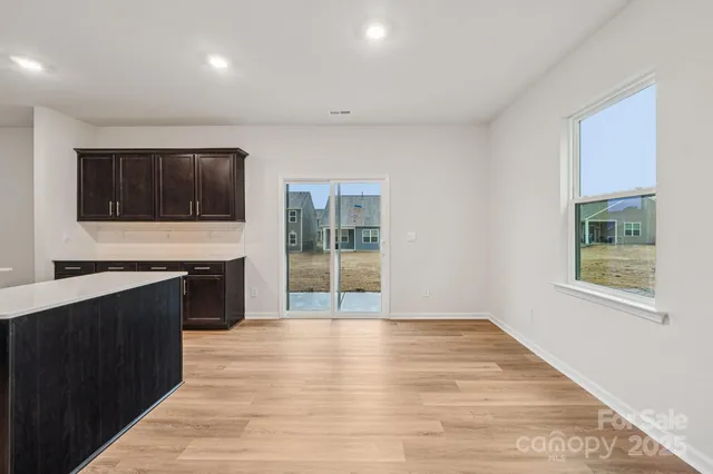 a view of kitchen with microwave oven and cabinets