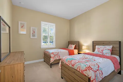 a bedroom with two beds and a night stand