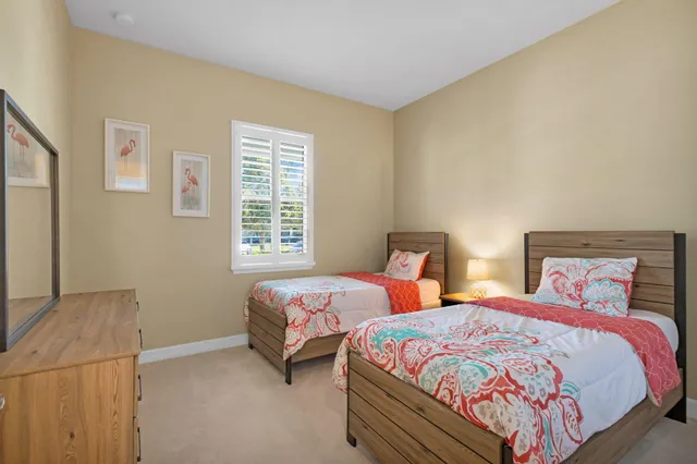 a bedroom with two beds and a night stand