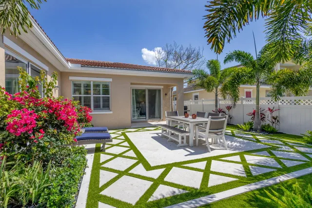 a view of a house with backyard and sitting area
