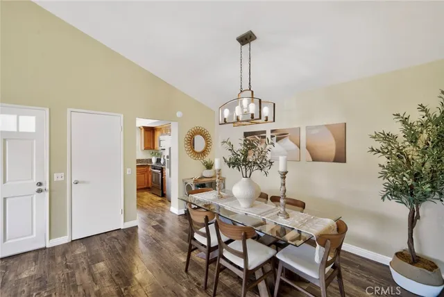 a view of a dining room with furniture wooden floor and chandelier