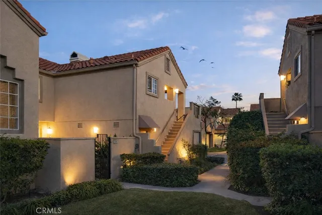 a front view of a house with a yard and plants