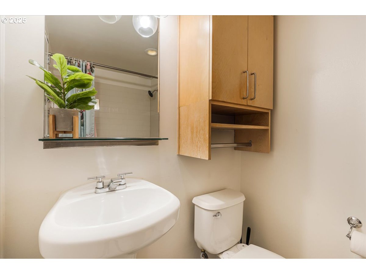 255 Southwest Harrison Street, Unit 11A Portland, OR 97201 - Photo 22 of 32 a bathroom with a sink a toilet and mirror