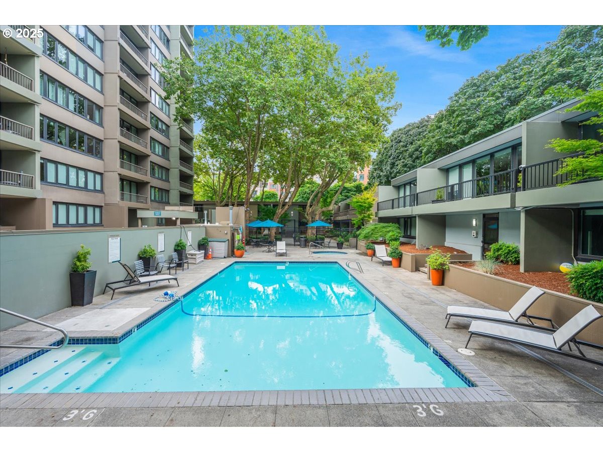 255 Southwest Harrison Street, Unit 11A Portland, OR 97201 - Photo 24 of 32 a view of a patio with table and chairs with wooden floor and fence