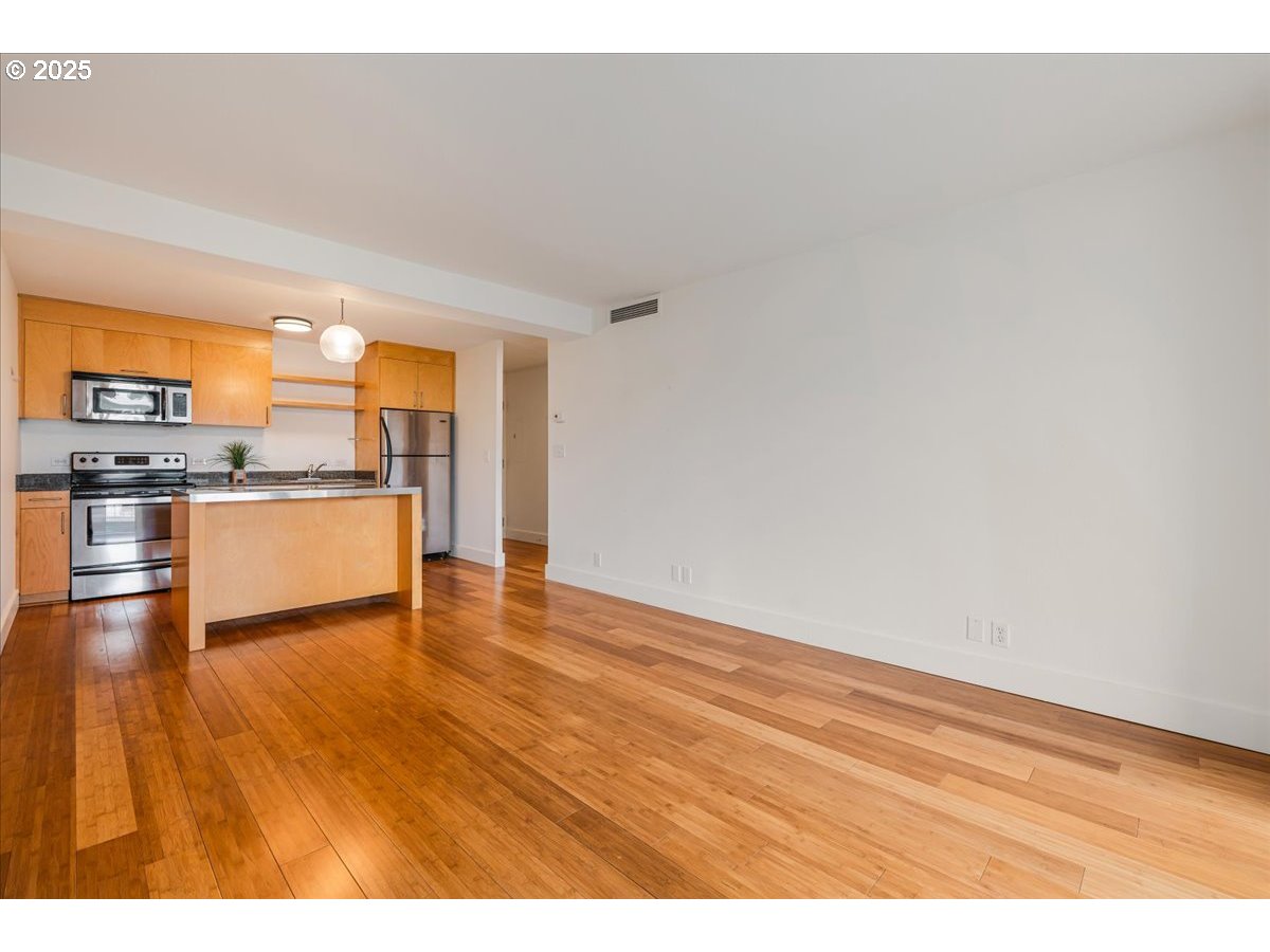 255 Southwest Harrison Street, Unit 11A Portland, OR 97201 - Photo 8 of 32 a view of a kitchen with wooden floor