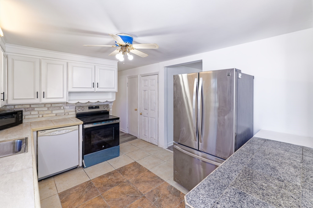 1 Rockland Rd Court Auburn, MA 01501 - Photo 12 of 38 a kitchen with stainless steel appliances granite countertop a refrigerator and a sink