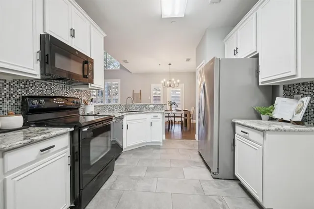 a bathroom with a granite countertop sink a toilet and mirror