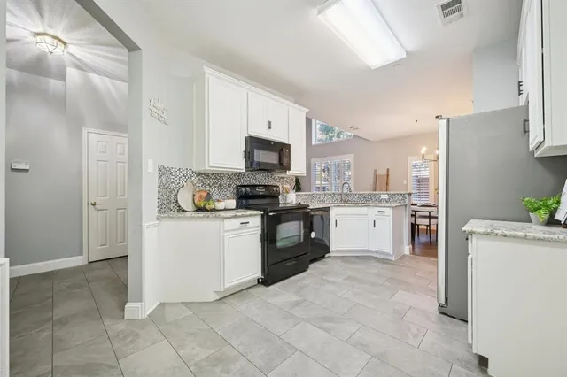 a kitchen with a refrigerator stove and sink