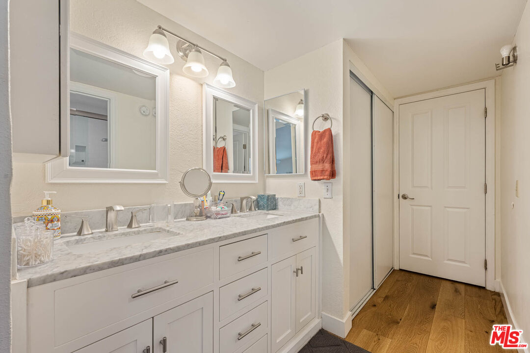 1515 South Beverly Drive, Unit 201 Los Angeles, CA 90035 - Photo 12 of 22 a en suite bathroom with a sink and a mirror