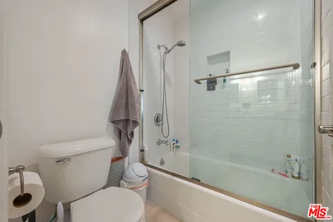 a bathroom with a granite countertop toilet a sink and bathtub