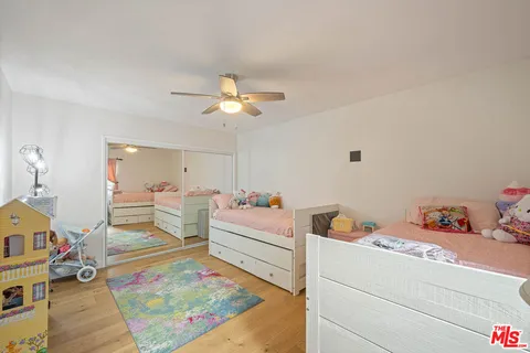 a living room with baby crib furniture and a dining table