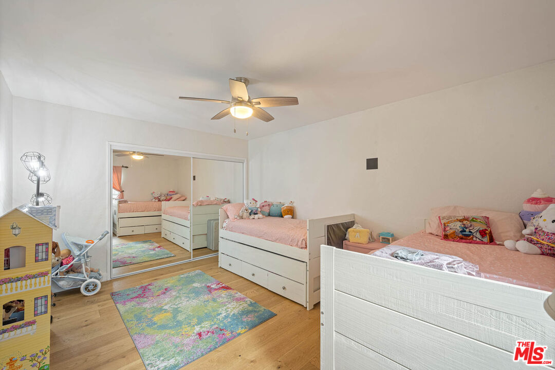 1515 South Beverly Drive, Unit 201 Los Angeles, CA 90035 - Photo 14 of 22 a living room with baby crib furniture and a dining table