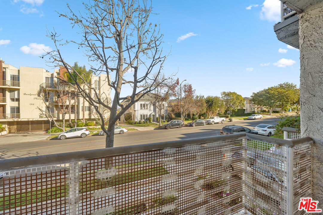 1515 South Beverly Drive, Unit 201 Los Angeles, CA 90035 - Photo 5 of 22 a view of a yard and trees in the background