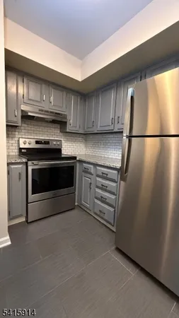 a kitchen with cabinets and stainless steel appliances