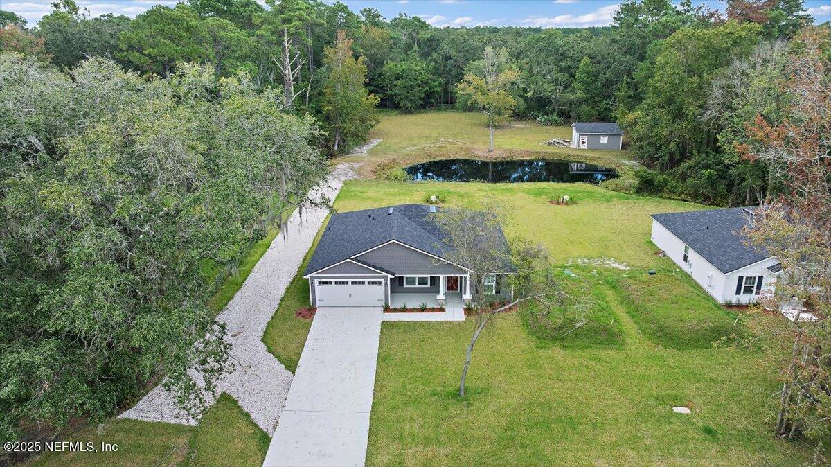 13185 Yellow Bluff Road Jacksonville, FL 32226 - Photo 3 of 28 an aerial view of a house with swimming pool a yard and large trees