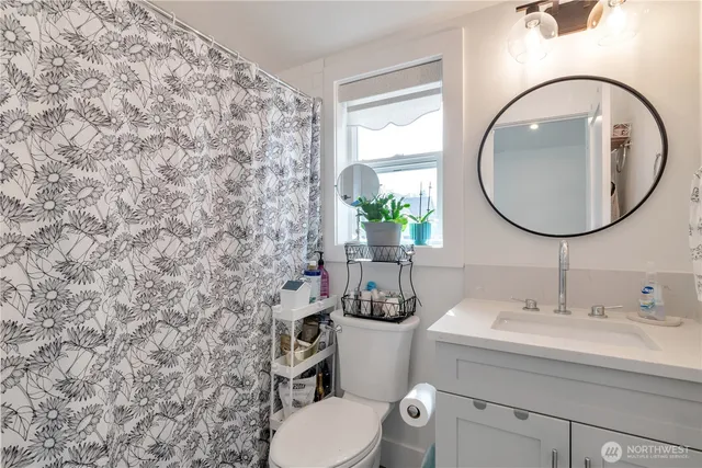a bathroom with a toilet sink and mirror