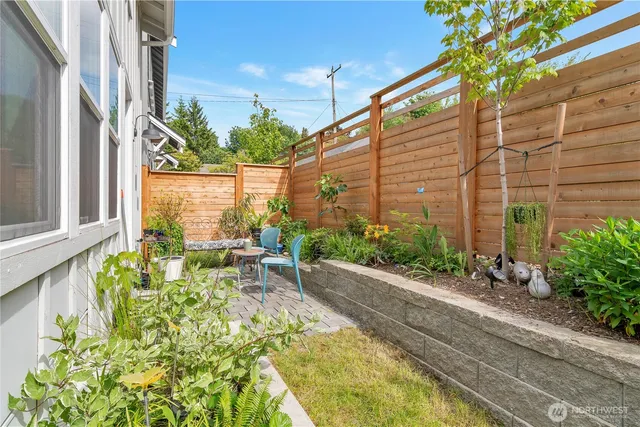 a front view of a house with a garden and sitting area