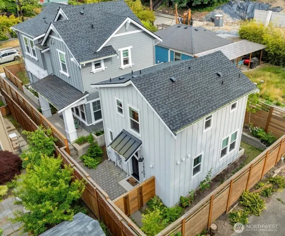 an aerial view of residential houses with deck and yard