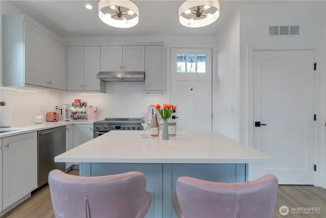 a kitchen with a table and chairs in it