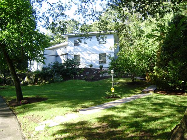 80 Hallwood Road Brookline, MA 02467 - Photo 1 of 11 a backyard of a house with lots of green space