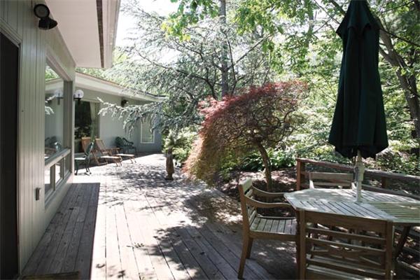 80 Hallwood Road Brookline, MA 02467 - Photo 3 of 11 a view of a patio with table and chairs and potted plants