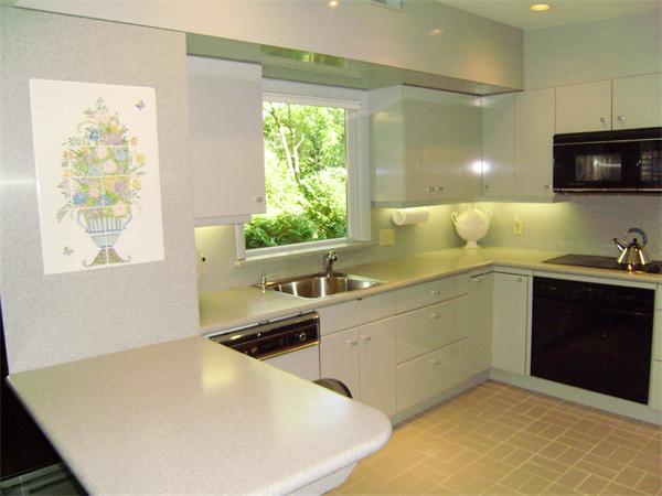 80 Hallwood Road Brookline, MA 02467 - Photo 5 of 11 a kitchen with a sink a window and appliances