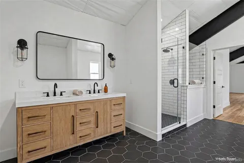 a bathroom with a double vanity sink mirror and