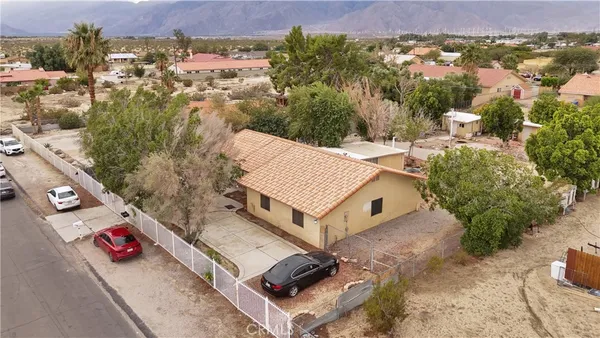 an aerial view of a house with a yard