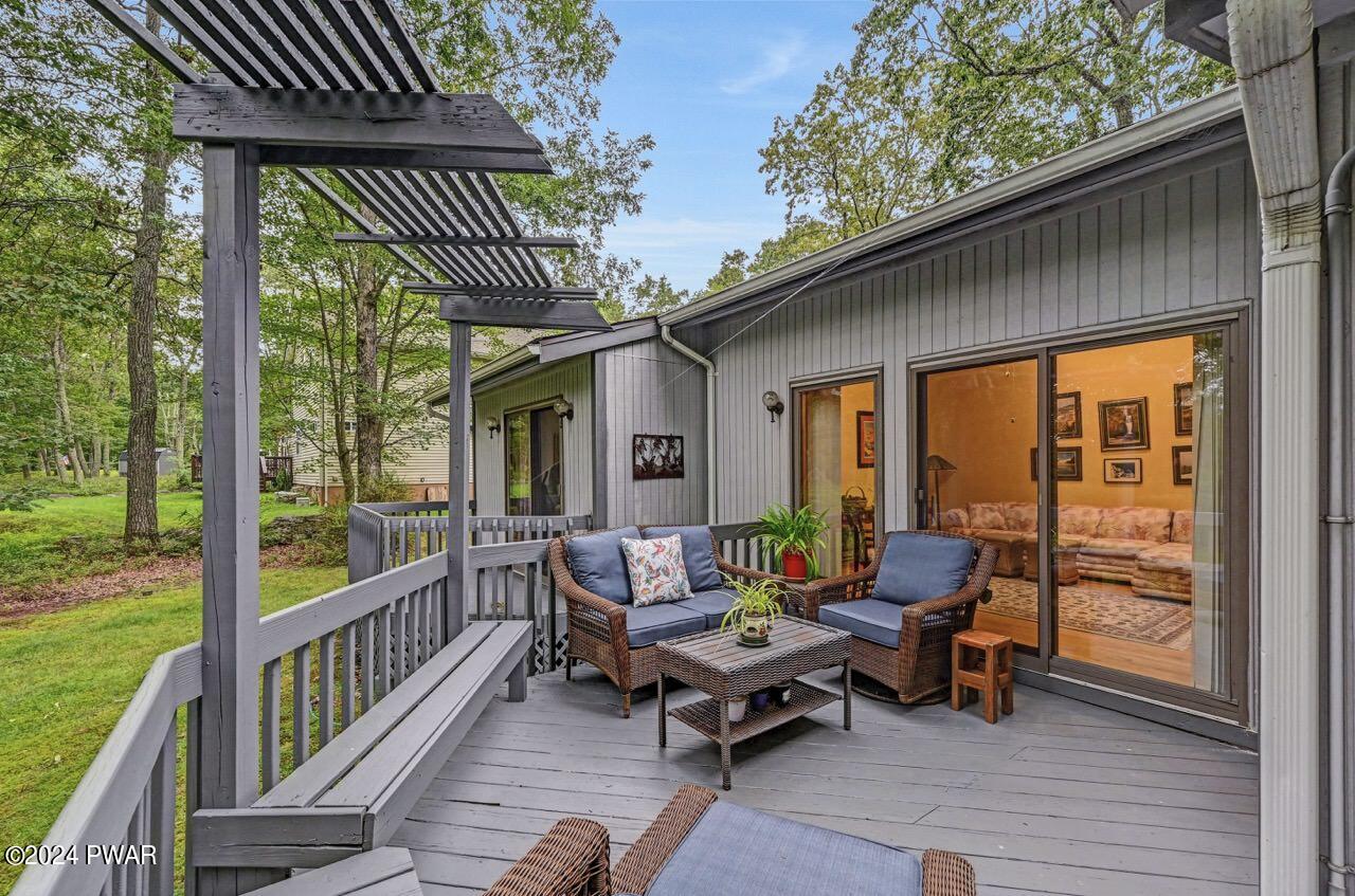 141 Maple Ridge Drive Hawley, PA 18428 - Photo 6 of 84 a roof deck with table and chairs and wooden floor