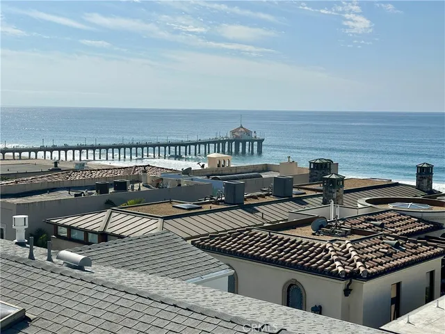a roof deck with a dining table and chairs