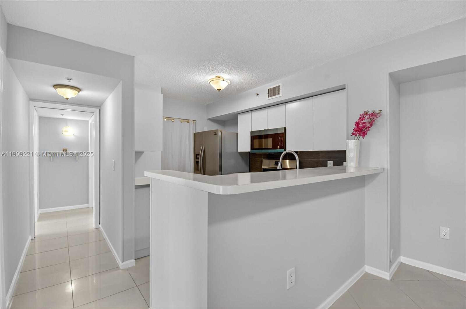 2123 Renaissance Boulevard, Unit 104 Miramar, FL 33025 - Photo 11 of 34 a view of kitchen with sink refrigerator and window