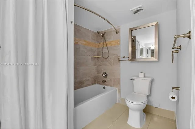a view of a kitchen with cabinets and wooden floor