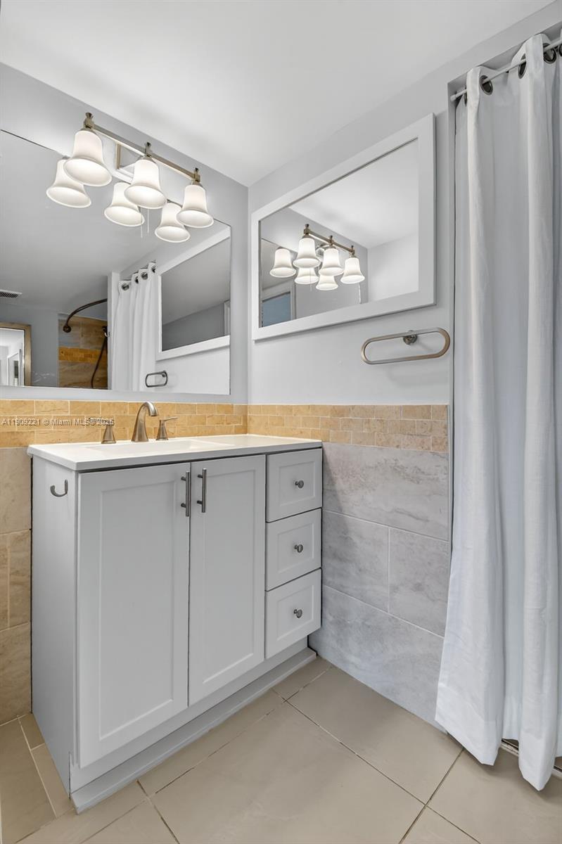 2123 Renaissance Boulevard, Unit 104 Miramar, FL 33025 - Photo 15 of 34 a view of a kitchen with cabinets and wooden floor