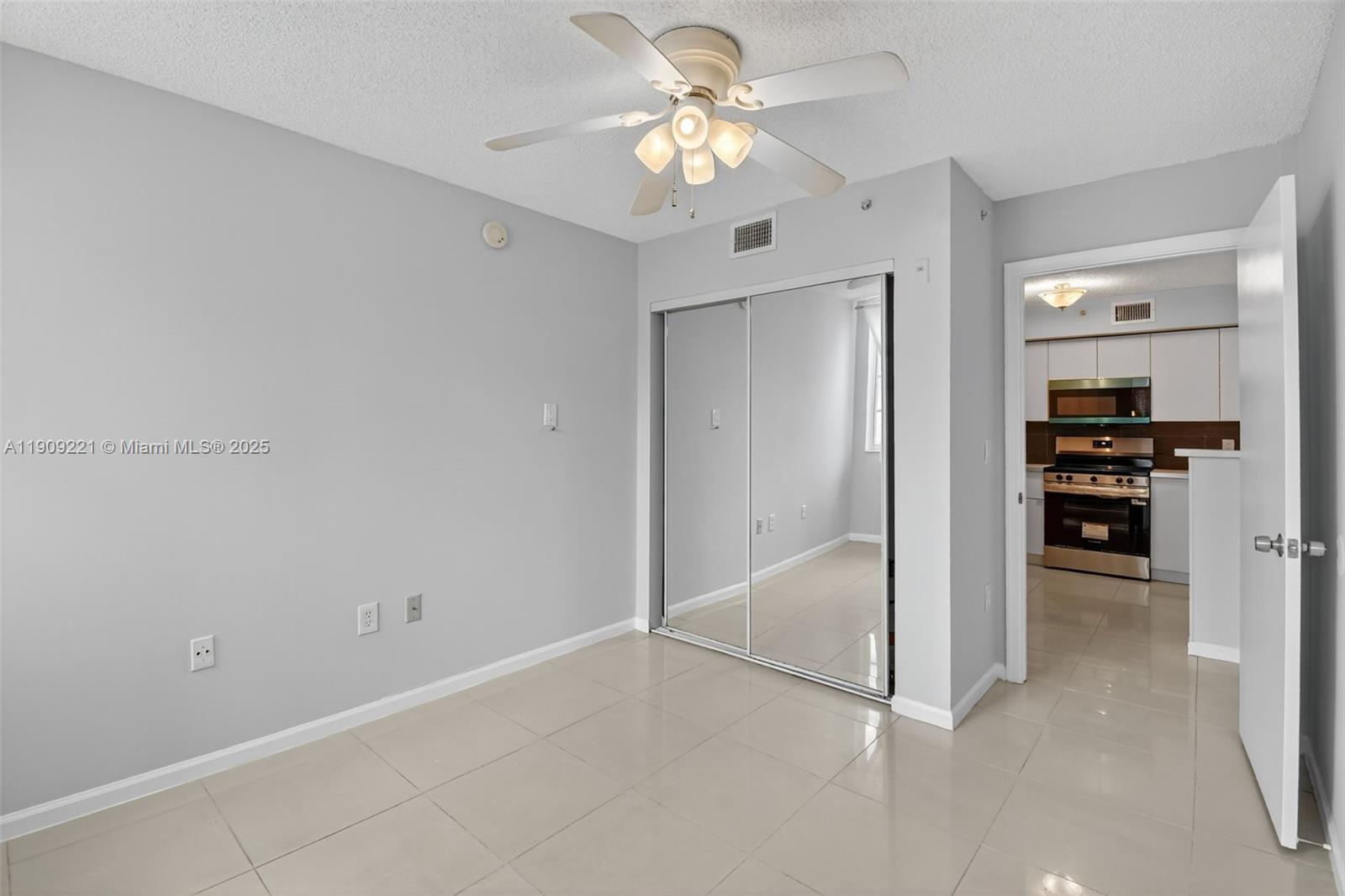 2123 Renaissance Boulevard, Unit 104 Miramar, FL 33025 - Photo 17 of 34 an empty room with closet and a ceiling fan