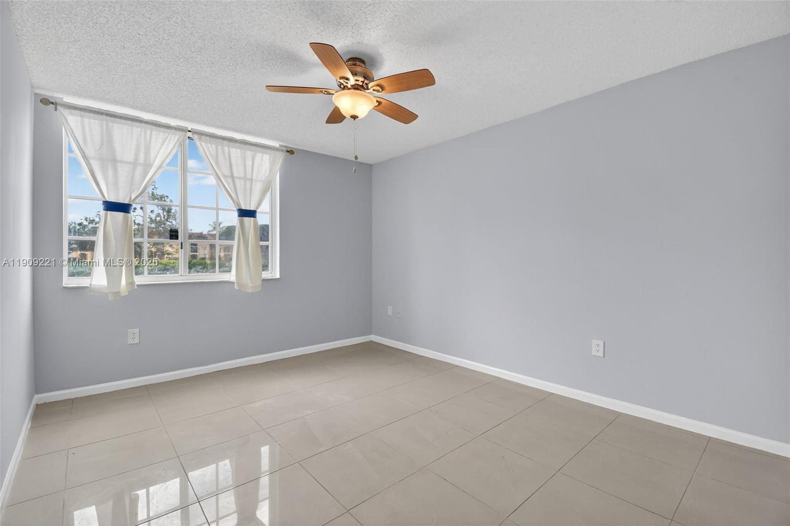 2123 Renaissance Boulevard, Unit 104 Miramar, FL 33025 - Photo 18 of 34 an empty room with windows and fan