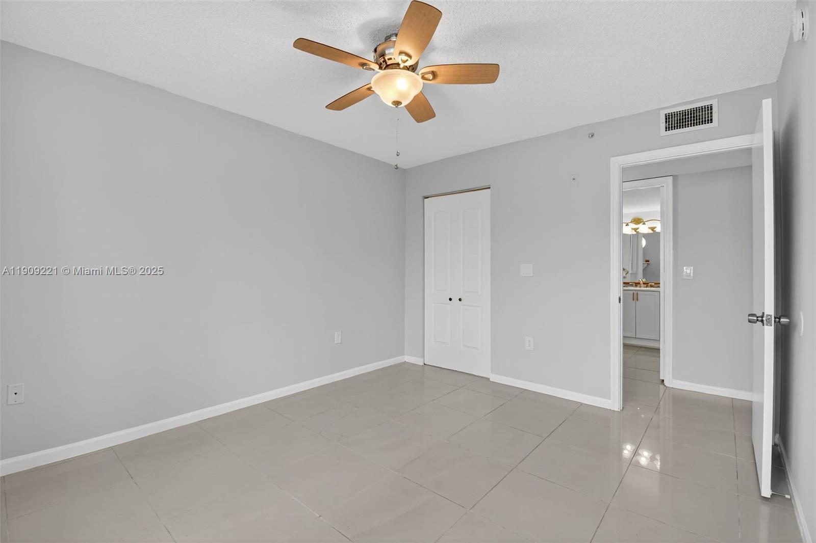 2123 Renaissance Boulevard, Unit 104 Miramar, FL 33025 - Photo 19 of 34 an empty room with closet and a chandelier fan
