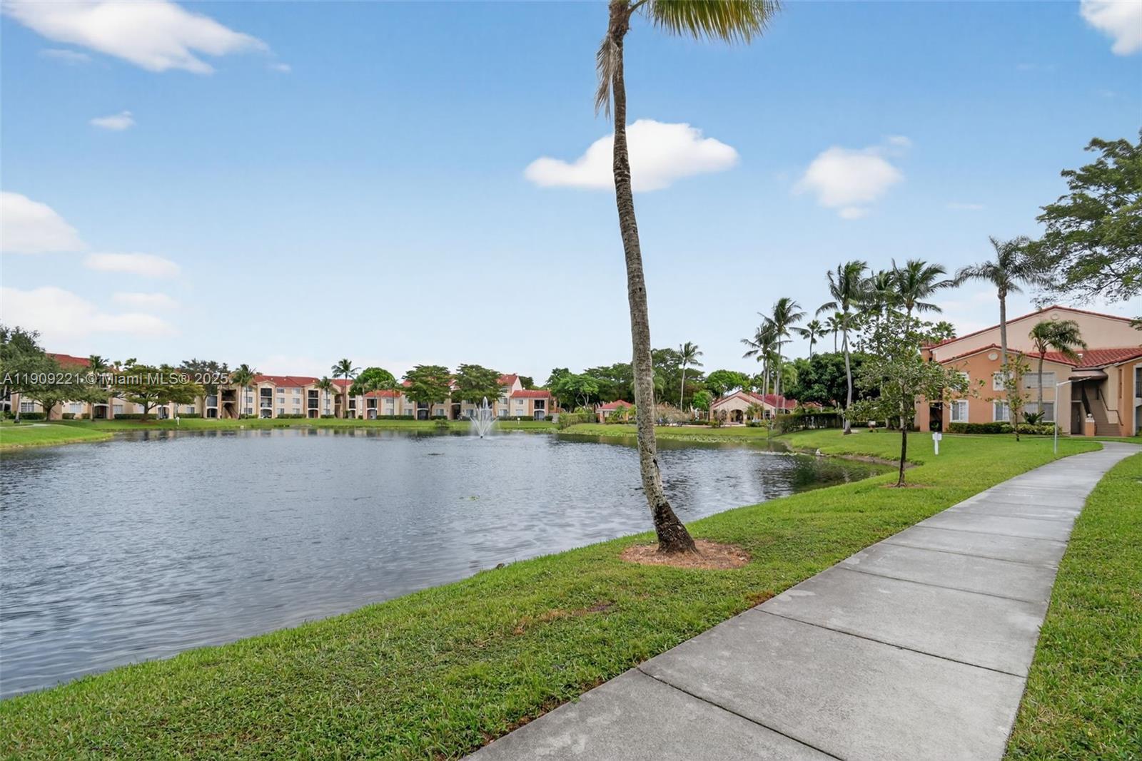 2123 Renaissance Boulevard, Unit 104 Miramar, FL 33025 - Photo 28 of 34 a lake view with a big yard and palm trees