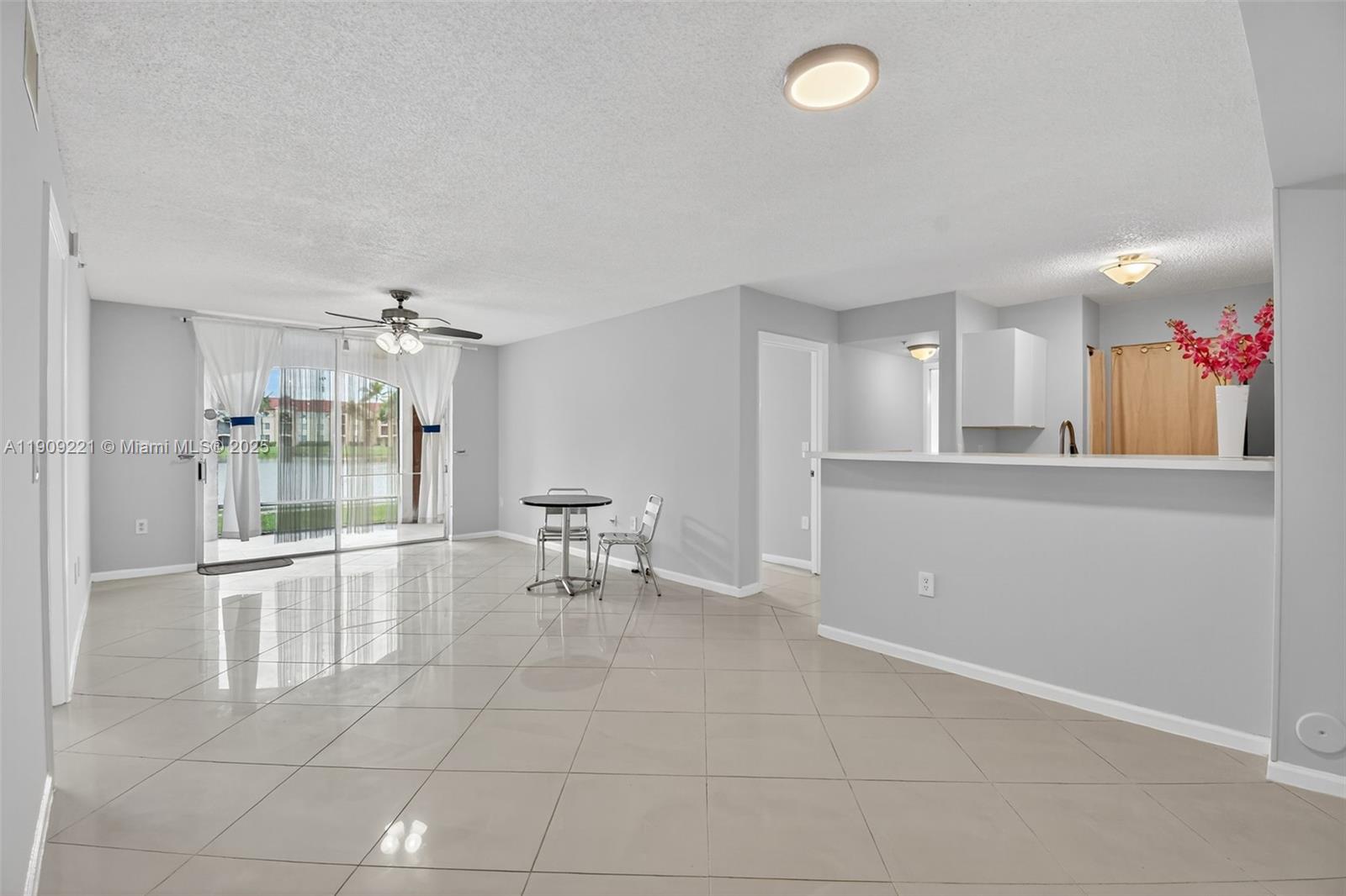 2123 Renaissance Boulevard, Unit 104 Miramar, FL 33025 - Photo 9 of 34 a living room with furniture and a table