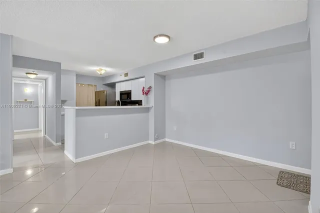 a view of kitchen with sink refrigerator and window