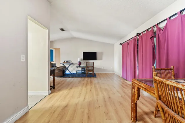 a view of a living room with furniture and a flat screen tv