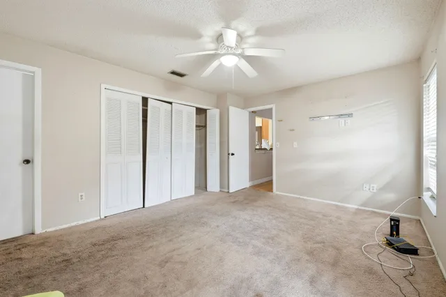 a view of a livingroom with a ceiling fan and window