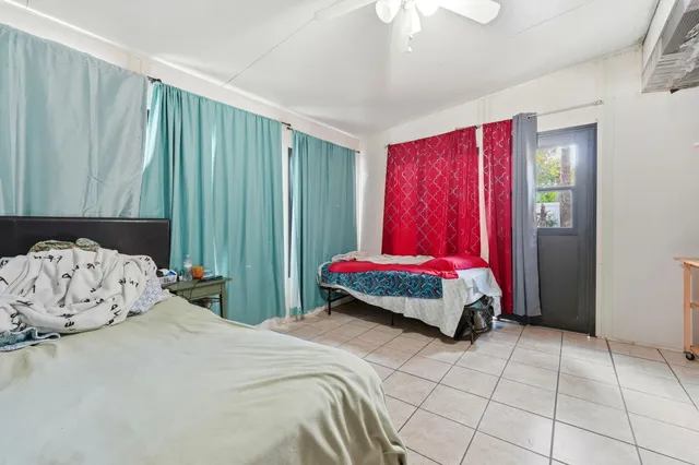 a bedroom with a bed and a chair